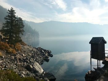 Scenic view of lake and mountains against sky