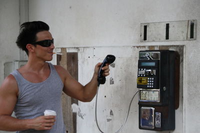 Man using payphone