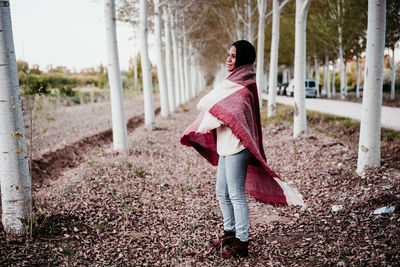 Side view of woman standing on field