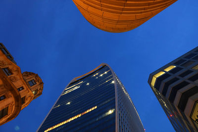 Low angle view of buildings against blue sky