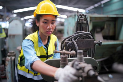 Rear view of man working in factory