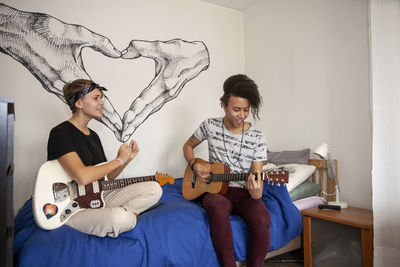 Young people playing guitars