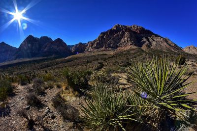 Scenic view of mountains against clear blue sky