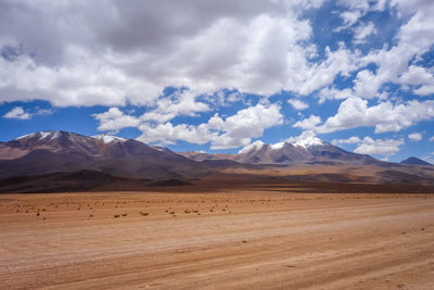 Scenic view of arid landscape against sky