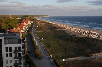 High angle view of sea and buildings against sky