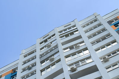 Low angle view of modern building against clear blue sky