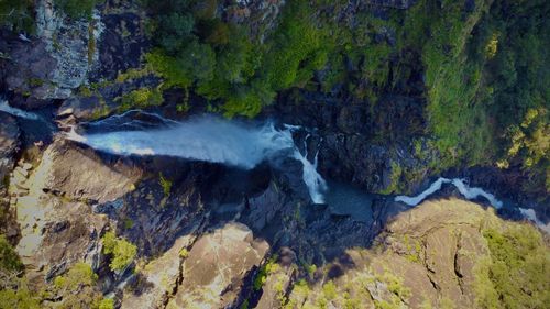 View of stream flowing through rocks