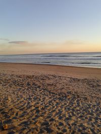 Scenic view of beach against sky during sunset