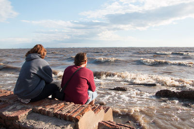 Couple sitting by the sea