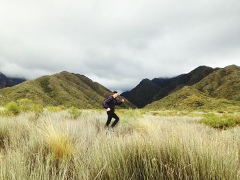 Man on field against mountain range