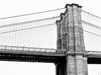 Low angle view of suspension bridge against sky