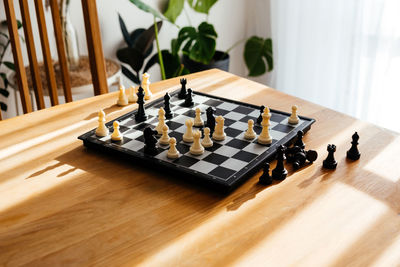 High angle view of chess board on table at home