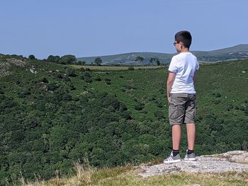 Full length of man standing on mountain against sky