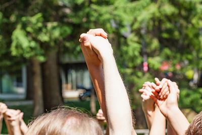 Cropped image of people holding hands