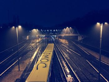 High angle view of railroad tracks against sky at night