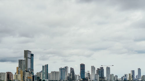 Cityscape against cloudy sky