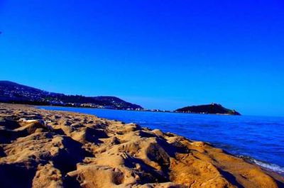 Scenic view of sea against clear blue sky