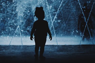 Silhouette girl against water fountain