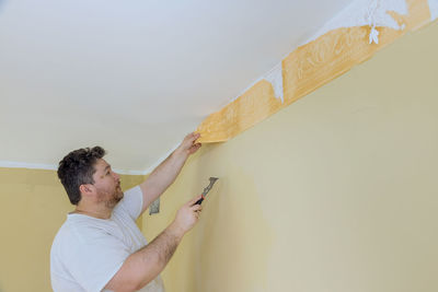 Man working on wall at home