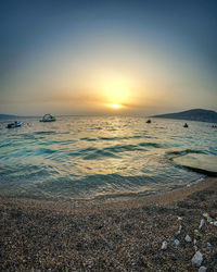 Scenic view of sea against clear sky during sunset