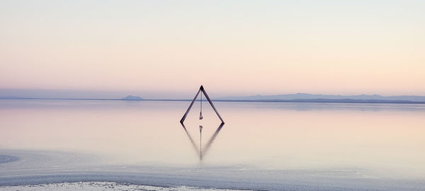 Scenic view of sea against clear sky during sunset