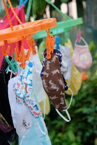 Close-up of multi colored clothespins hanging on market stall