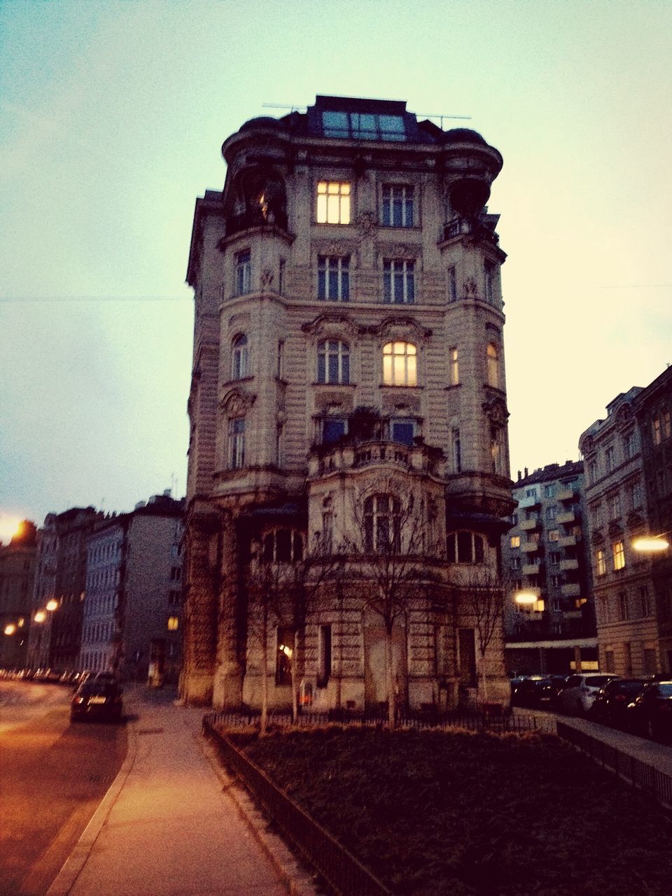 building exterior, architecture, built structure, street, city, transportation, sky, road, illuminated, street light, building, car, outdoors, city street, dusk, travel destinations, land vehicle, the way forward, city life, no people