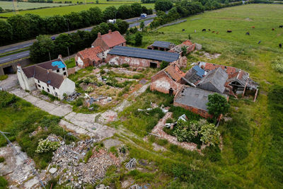 High angle view of houses and trees on field