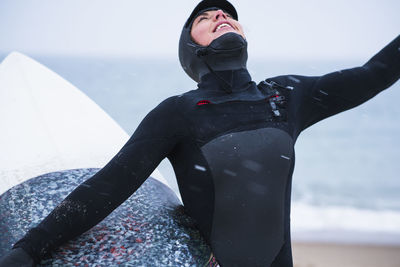 Young woman going winter surfing in snow