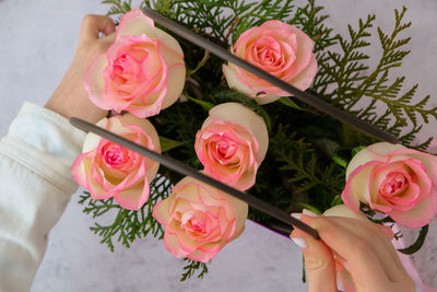 Midsection of bride holding bouquet