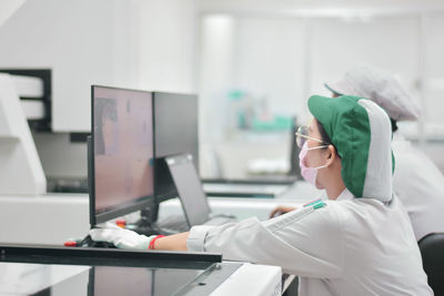 Side view of scientist working in laboratory