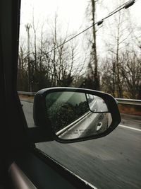 Close-up of side-view mirror of car