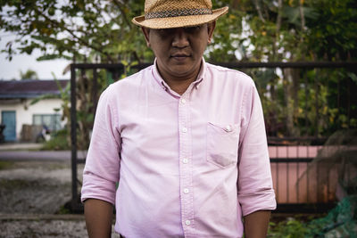 Man wearing hat in yard