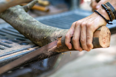 Close-up of man working on wood