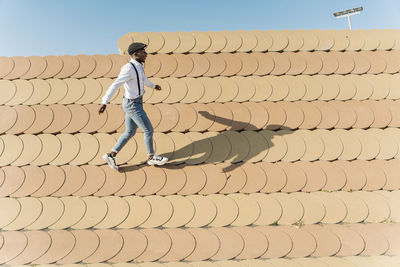 Rear view of man walking on roof