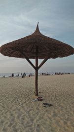 Lifeguard hut on beach against sky