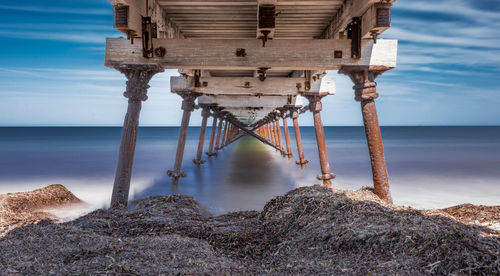 Pier on sea against sky