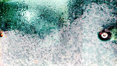 Full frame shot of wet window in swimming pool