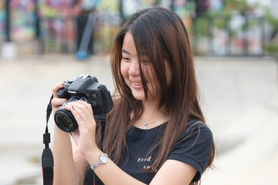 Portrait of woman photographing