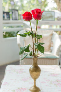 Close-up of rose flower vase on table