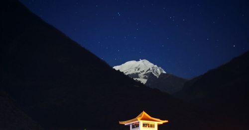 Scenic view of mountains against clear sky at night