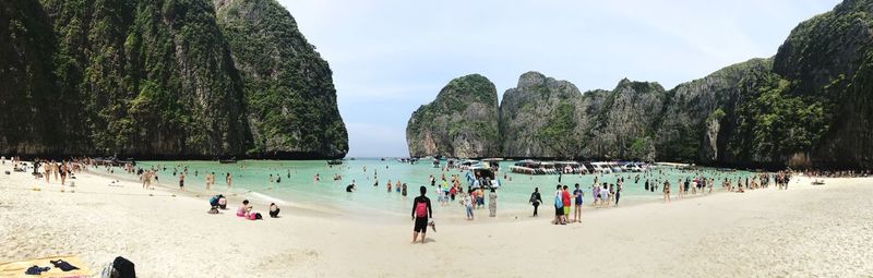 People on beach against sky