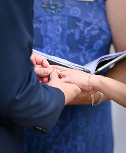 Closeup shot of the exchange of wedding or engagement ring
