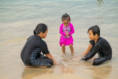 Young asian kids are playing on the beach. vacation and relax concept.