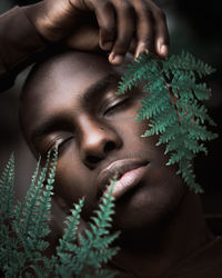 Close-up of young woman with plants