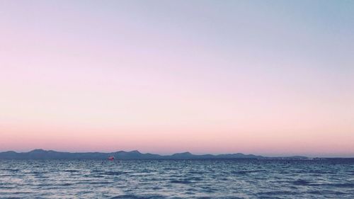 Scenic view of sea and mountains during sunset