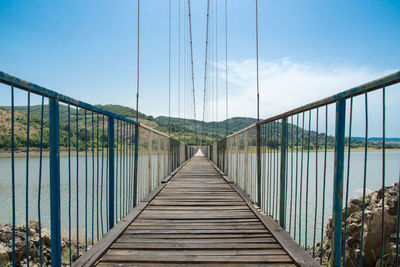 Footbridge against clear sky