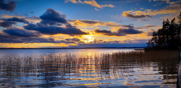 Scenic view of lake against sky during sunset