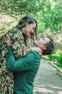 Side view of couple romancing at park