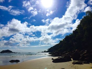 View of calm beach against blue sky